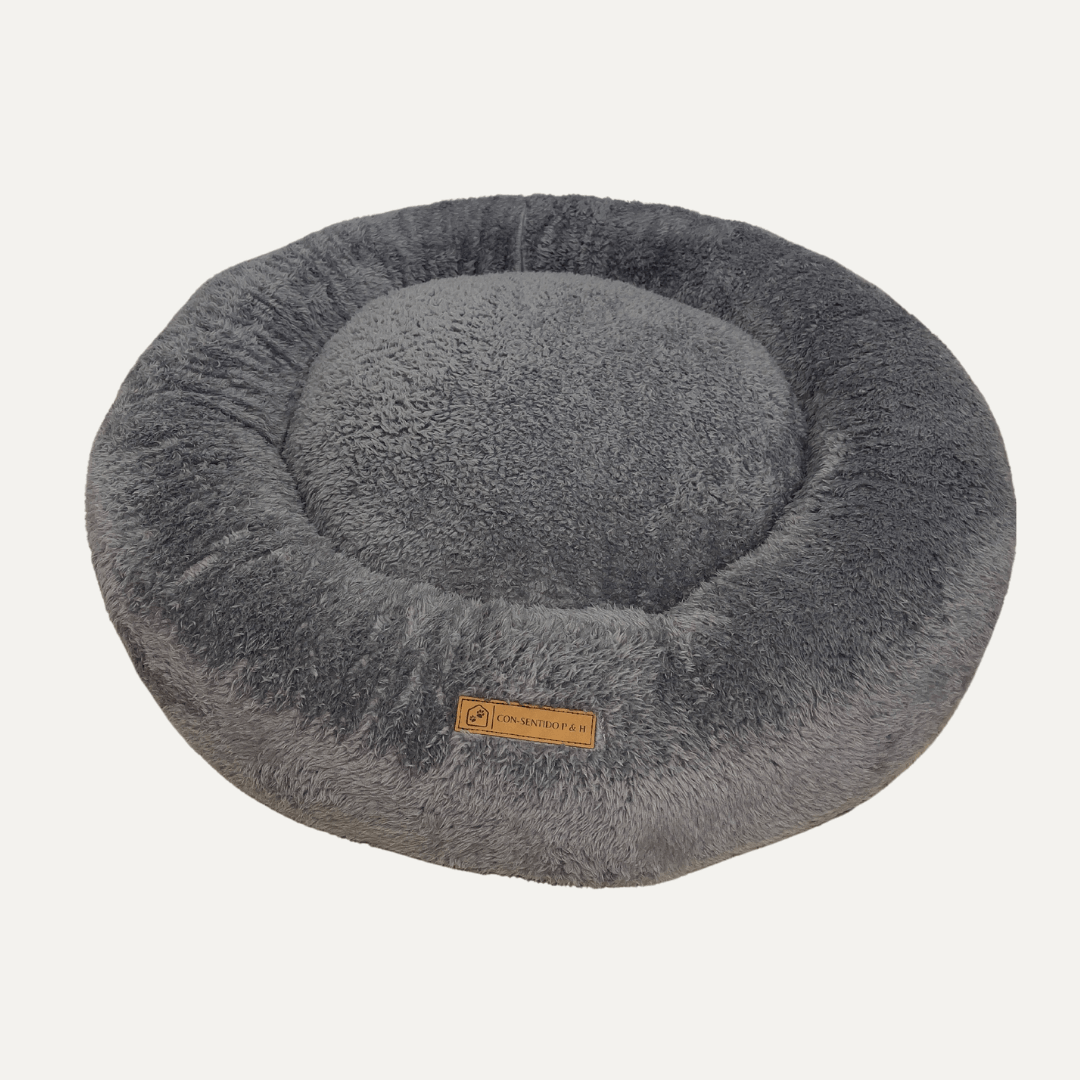 Cama Dona Ceiba antiestrés para perros y gatos en color rosado, diseñada con bordes elevados y materiales suaves para ofrecer un descanso cómodo.